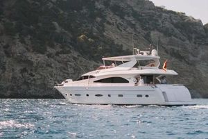 Astondoa 82 GLX Astondoa 82 GLX yacht cruising near rocky coastline, 2000 model.