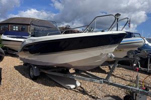 Quicksilver Activ 455 Open 2021 Quicksilver Activ 455 Open boat on trailer, displayed outdoors under cloudy sky.