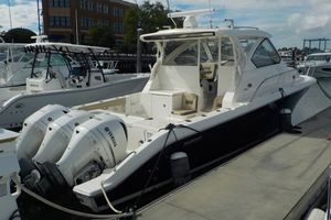 Pursuit OS 355 Offshore 2020 Pursuit OS 355 Offshore boat docked, featuring triple Yamaha outboard engines.