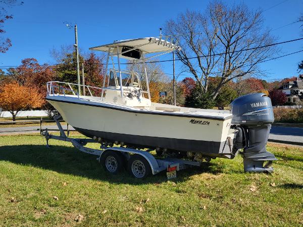 Mako 224 CC 1985 Mako 224 CC boat on trailer with Yamaha outboard, parked on grass.