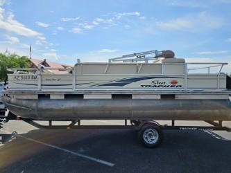 Sun Tracker FISHING BARGE 21 2008 Sun Tracker FISHING BARGE 21 pontoon boat on trailer, parked outdoors.