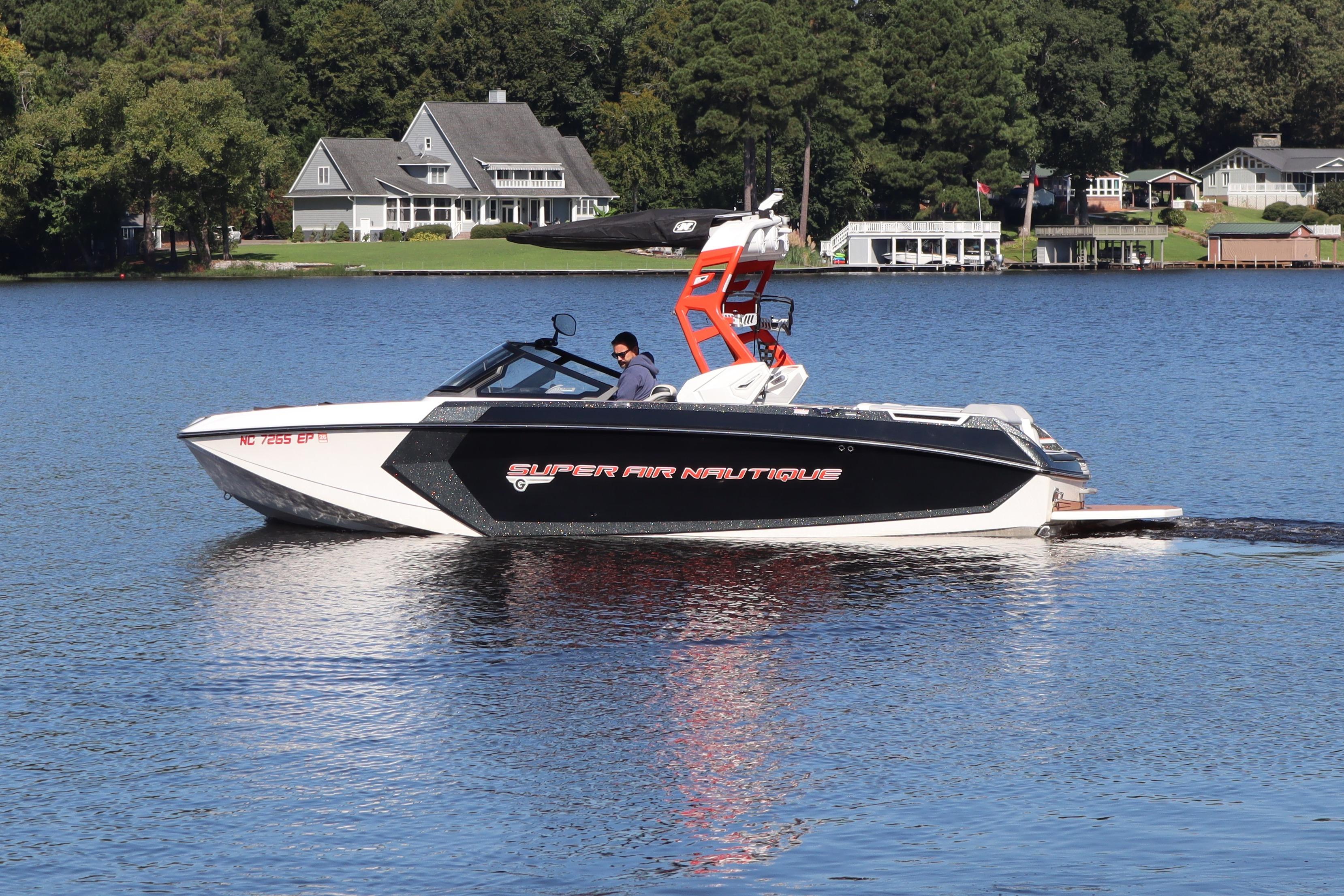Nautique Super Air Nautique G23 2020 Nautique Super Air Nautique G23 boat cruising on a serene lake.