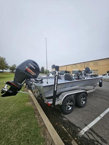 Xpress H20 Bass 2025 Express H20 Bass boat with Yamaha engine on trailer in parking lot.