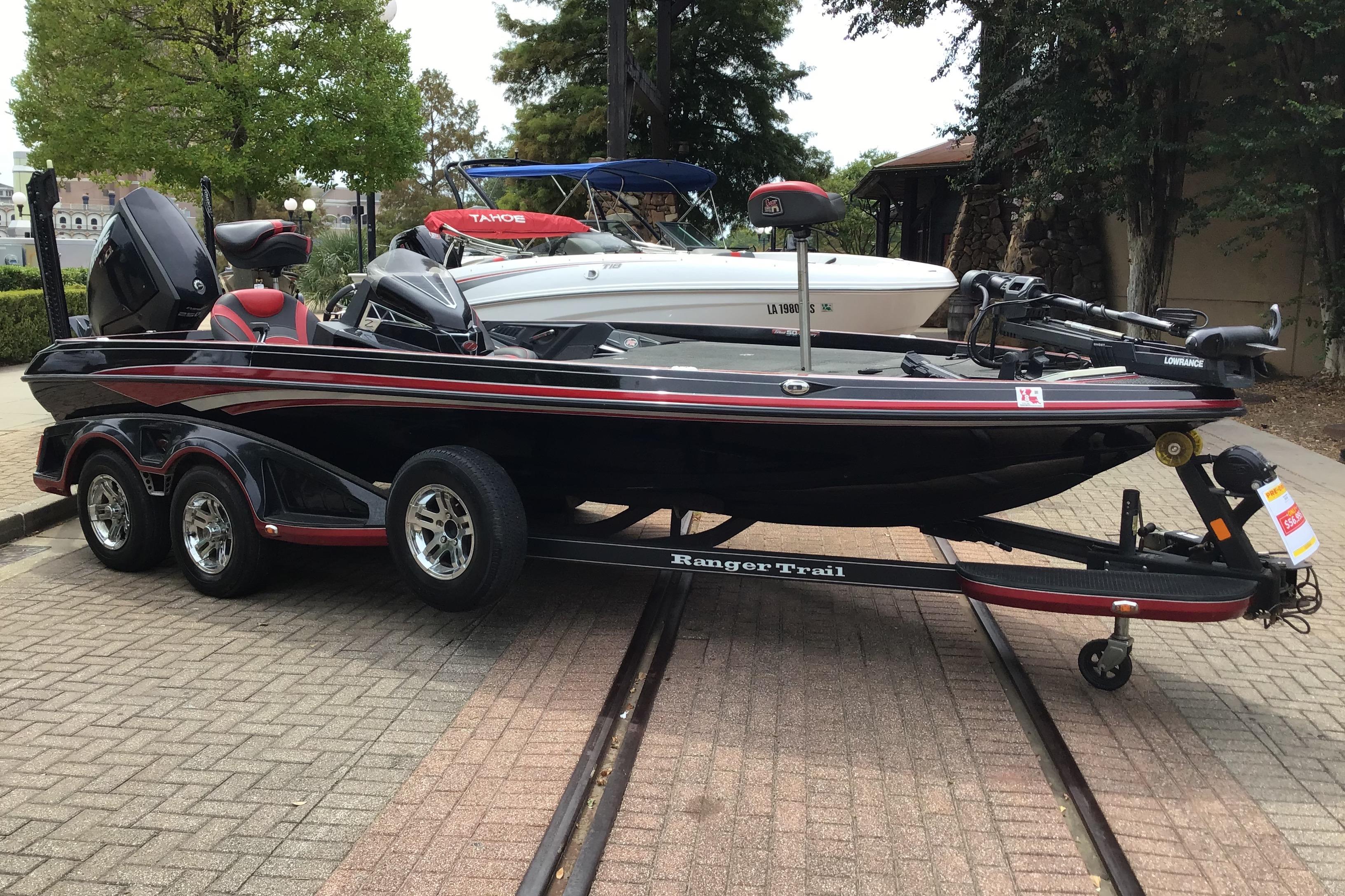Ranger Z520L 2018 Ranger Z520L boat on trailer, parked outdoors, with trees in the background.