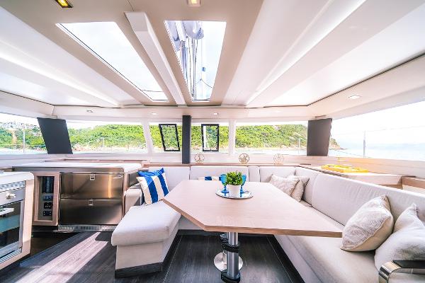 Fountaine Pajot Tanna 47 Luxurious interior of 2024 Fountaine Pajot Tanna 47 catamaran with modern furnishings and panoramic windows.