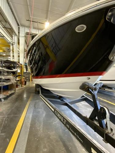 Cobalt R35 2025 Cobalt R35 boat in a workshop, showcasing sleek black and white design.