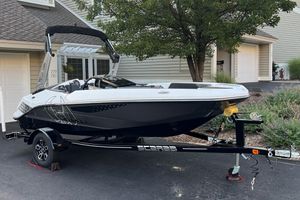 Scarab 165 H.O. Platinum 2023 Scarab 165 H.O. Platinum boat on trailer, parked in residential driveway.