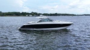 Cobalt A40 2015 Cobalt A40 boat on calm water, side view, under a partly cloudy sky.