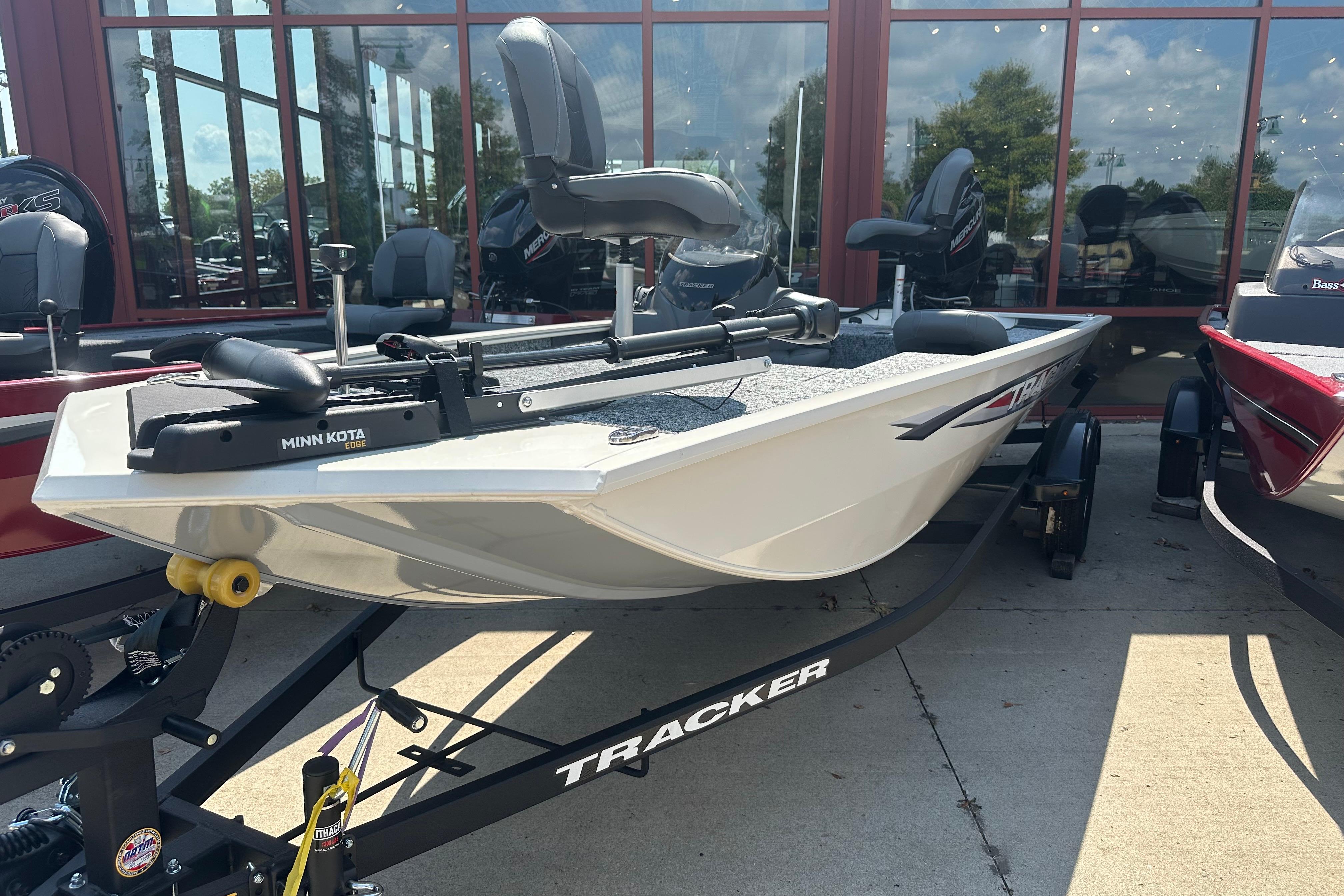Tracker Pro 170 2026 Tracker Pro 170 boat on trailer, displayed outdoors with Minn Kota motor.