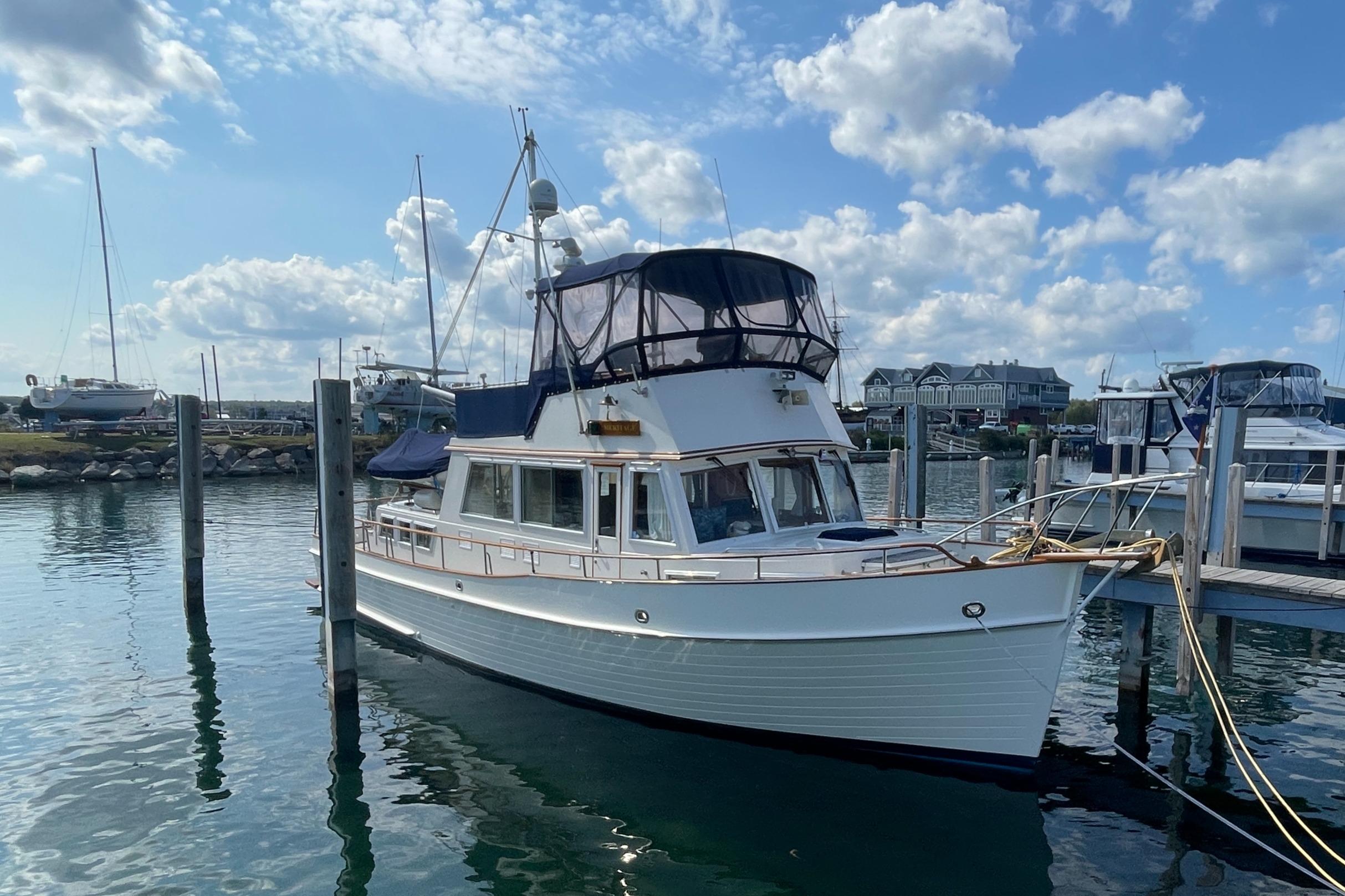 Grand Banks 42 Classic 1990 Grand Banks 42 Classic yacht docked in a marina under a blue sky.