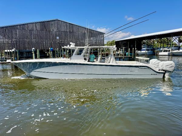 Invincible 46 Catamaran 2022 Invincible 46 Catamaran docked at marina, clear sky, calm water.