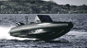 Iron 647 High-speed Iron 647 boat cruising on water, 2025 model, with rocky shoreline in background.