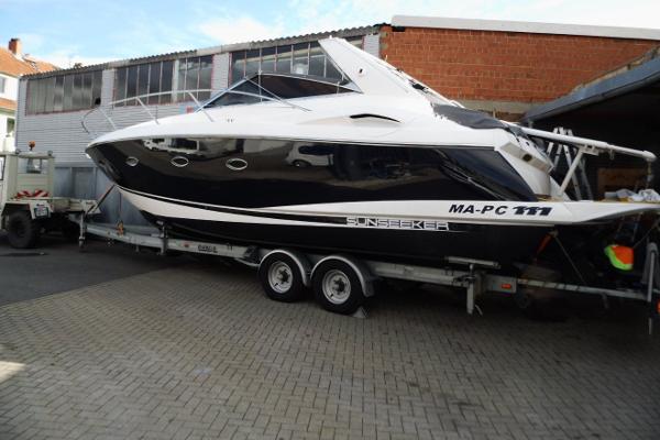 Sunseeker Portofino 35 2006 Sunseeker Portofino 35 yacht on trailer, parked in an industrial area.