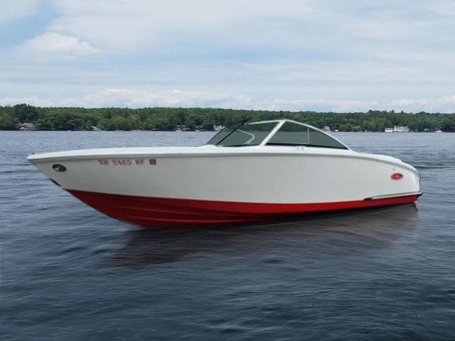 Cobalt CS23 2017 Cobalt CS23 boat with red hull on a calm lake.
