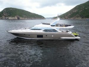 Azimut 66 2017 Azimut 66 yacht cruising in scenic waters between lush green hills.