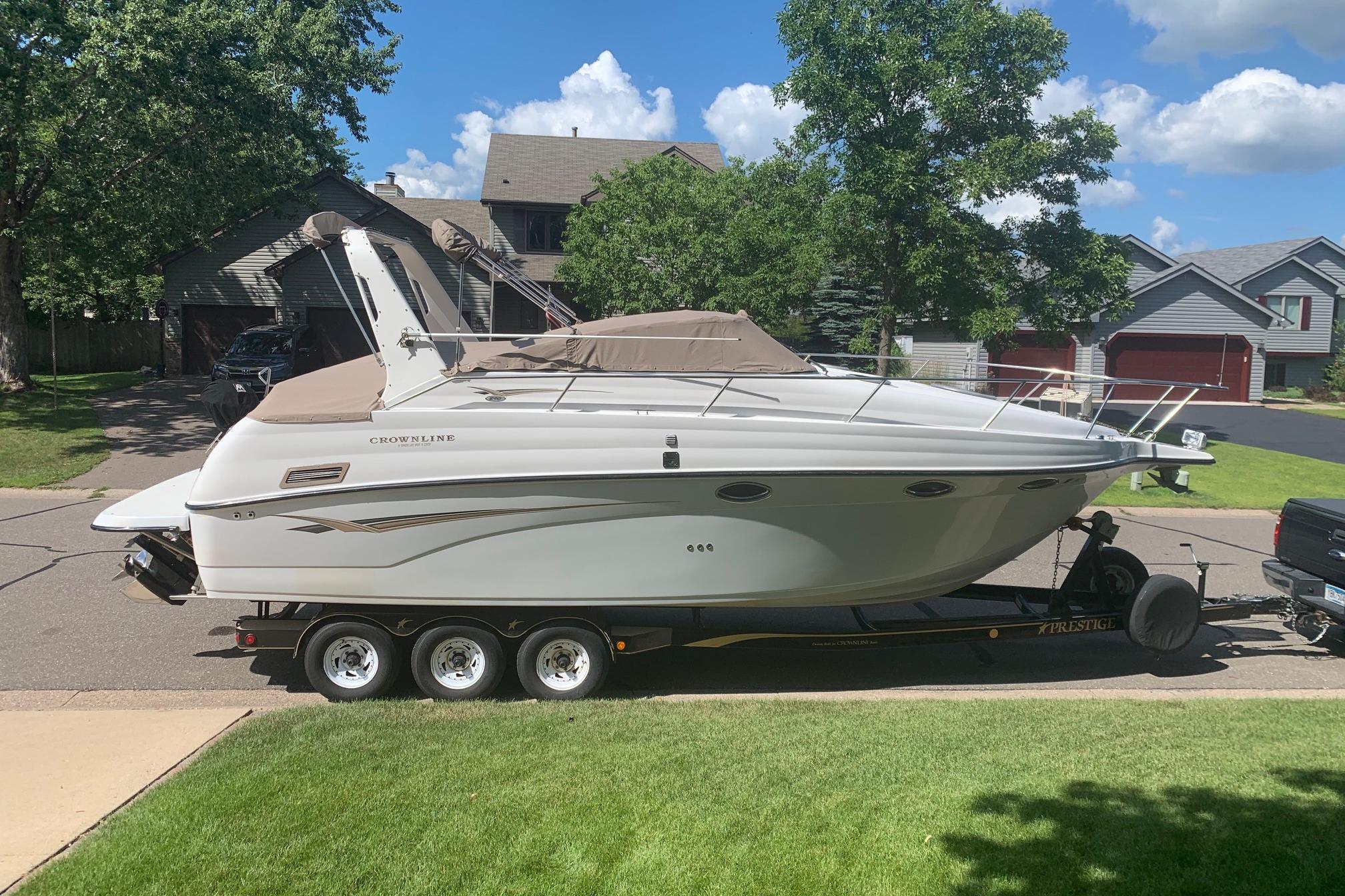 Crownline 290 CR 2002 Crownline 290 CR boat on trailer in suburban neighborhood.