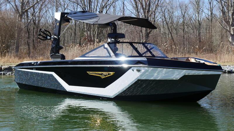 Nautique Super Air Nautique S23 2025 Nautique Super Air Nautique S23 boat on calm water, sleek design, black and white exterior.