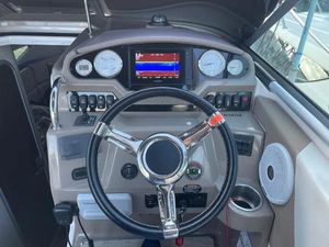 Regal 26 Express 2019 Regal 26 Express boat dashboard with steering wheel and navigation controls.