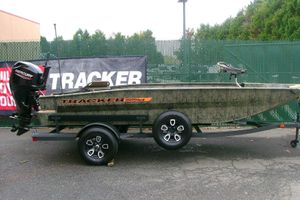 Tracker Grizzly 1756 T Marsh 2026 Tracker Grizzly 1756 T Marsh boat on trailer, displayed outdoors.