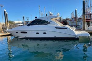Sea Ray 470 Sundancer 2012 Sea Ray 470 Sundancer yacht docked in a marina under clear blue skies.