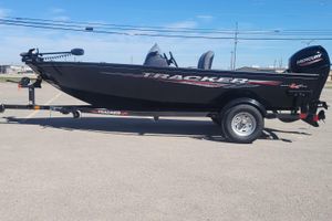 Tracker Super Guide V-16 SC 2026 Tracker Super Guide V-16 SC boat on trailer, featuring sleek black design and Mercury engine.