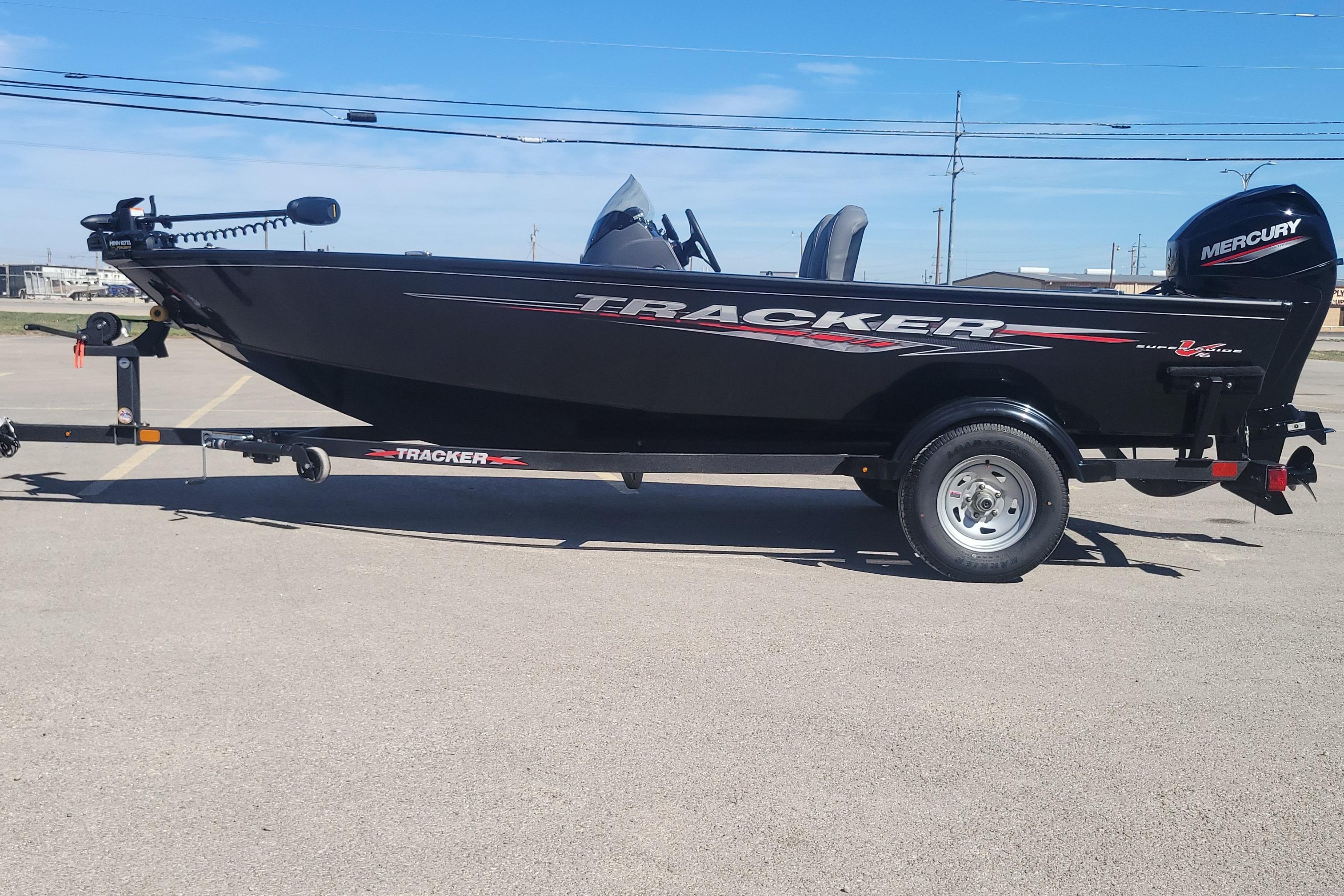 Tracker Super Guide V-16 SC 2026 Tracker Super Guide V-16 SC boat on trailer, featuring sleek black design and Mercury engine.