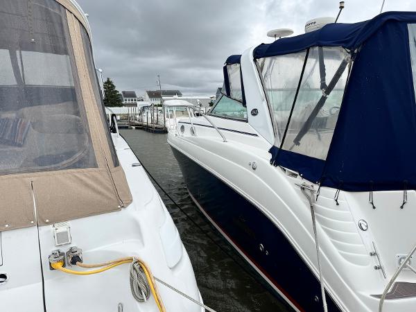 Rinker 342 Express Cruiser 2006 Rinker 342 Express Cruiser docked beside another boat under cloudy skies.