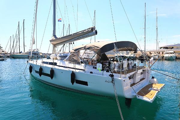Hanse 460 2022 Hanse 460 yacht docked in a marina, featuring sleek design and modern amenities.