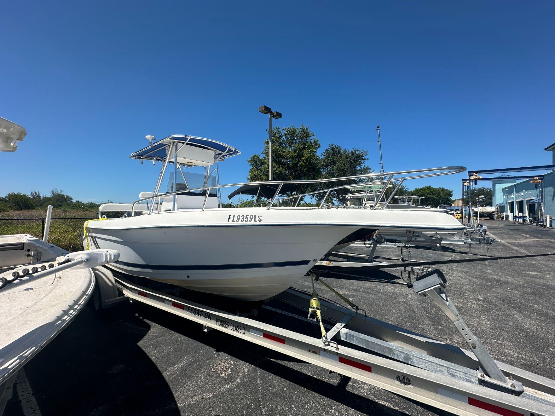 Cobia 234 Center Console 2001 Cobia 234 Center Console boat on trailer under clear blue sky.