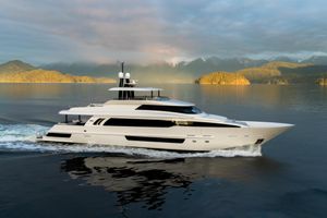 Crescent Raised Pilothouse Luxurious 2019 Crescent Semi-Displacement yacht cruising on serene waters with scenic mountain backdrop.
