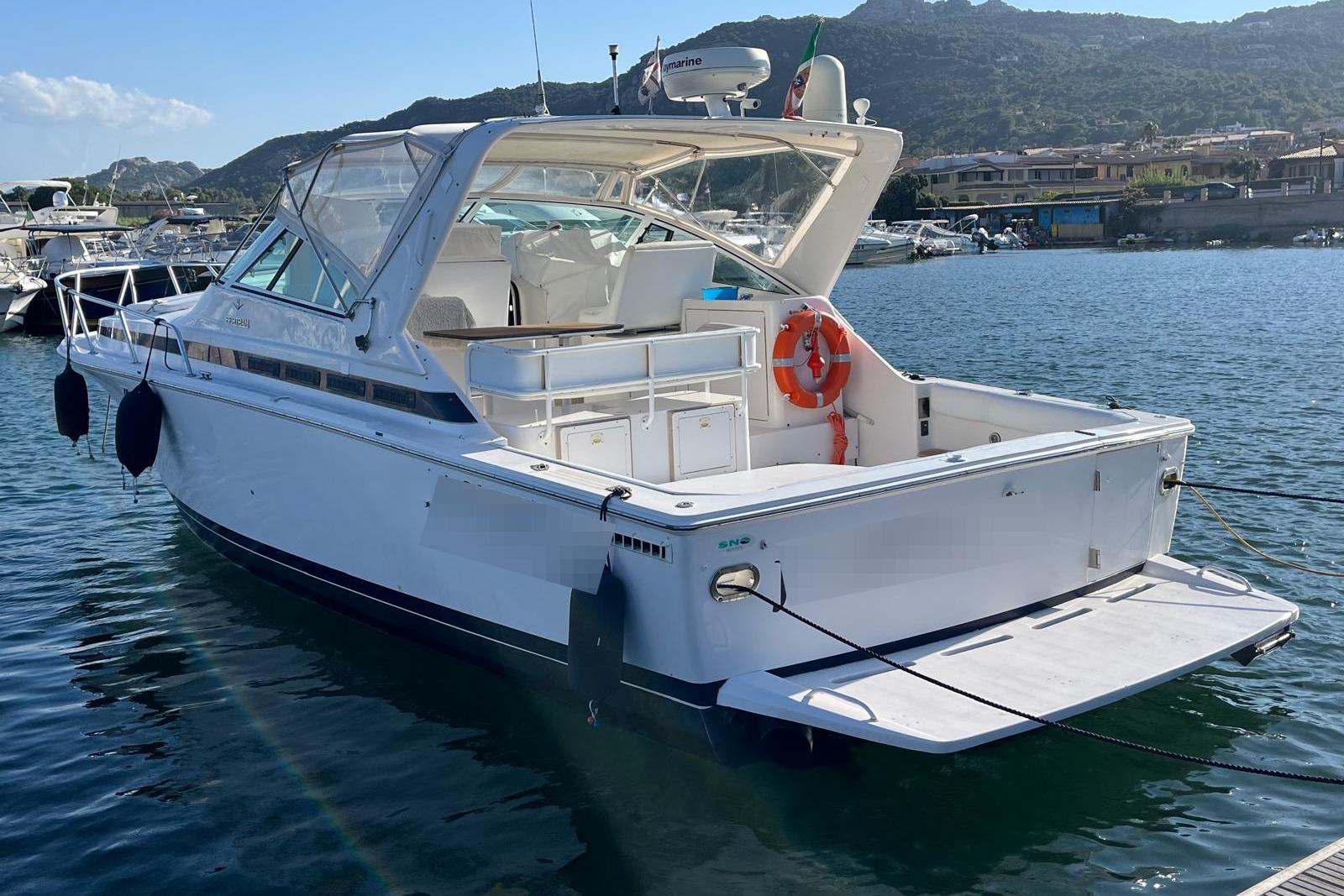 Bertram 36 Moppie 1999 Bertram 36 Moppie boat docked in a scenic marina with mountains in the background.