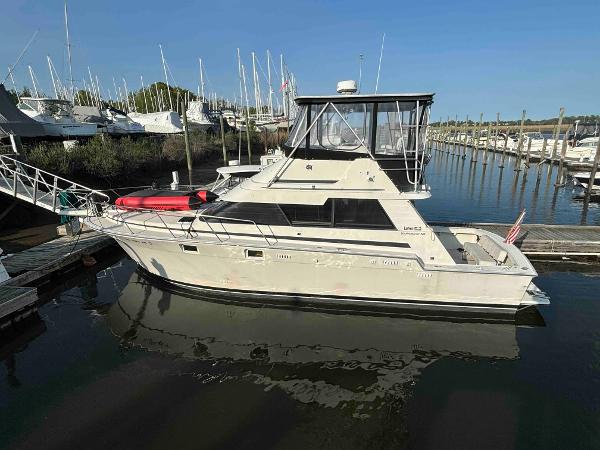 Luhrs Tournament 400 Convertible 1988 Luhrs Tournament 400 Convertible yacht docked in a marina, side view.