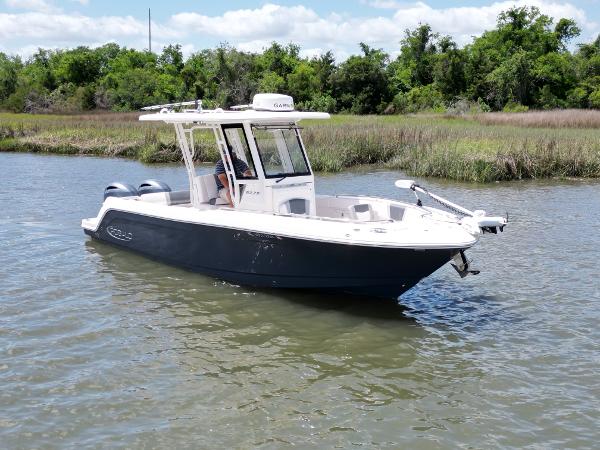 Robalo R272 Center Console 2020 Robalo R272 Center Console boat on calm water near lush greenery.