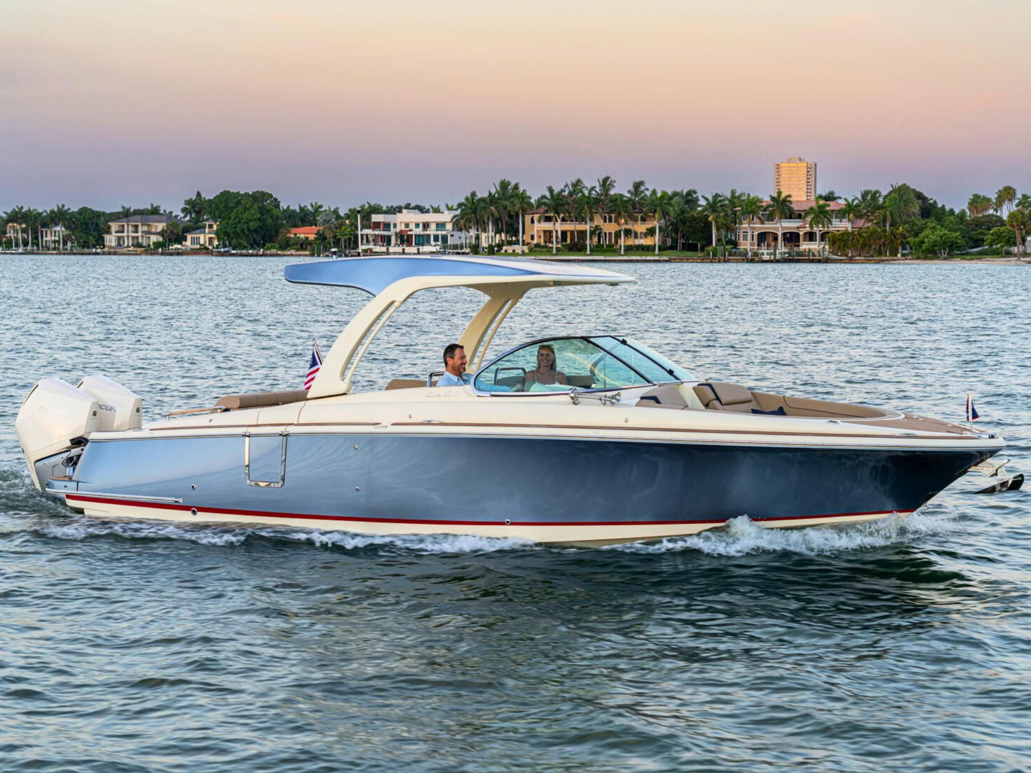Chris-Craft Launch 31 GT 2026 Chris-Craft Launch 31 GT cruising on a serene waterway at sunset.