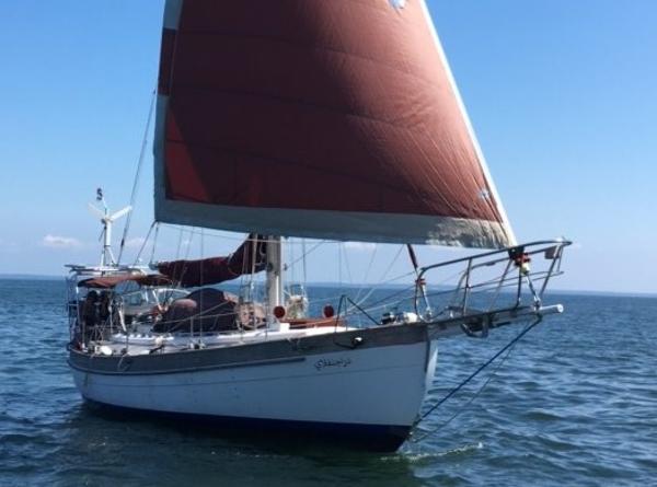 Hans Christian 38 1986 Hans Christian 38 sailboat with red sails on open water.