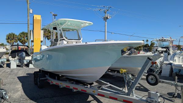 Key West 260 CC 2025 Key West 260 CC boat on trailer in sunny marina setting.