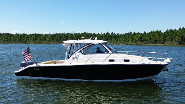 Pursuit 325 Offshore 2016 Pursuit 325 Offshore boat on a lake with forested background.