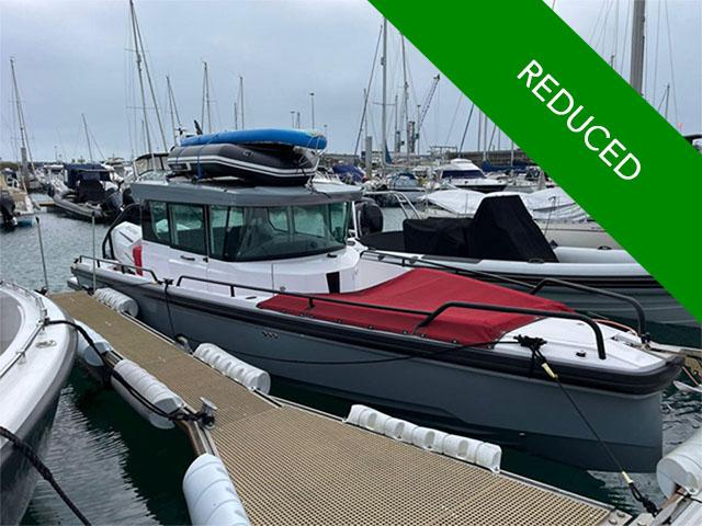 Axopar 28 2021 Axopar 28 boat docked, red cover, price reduced, marina background.