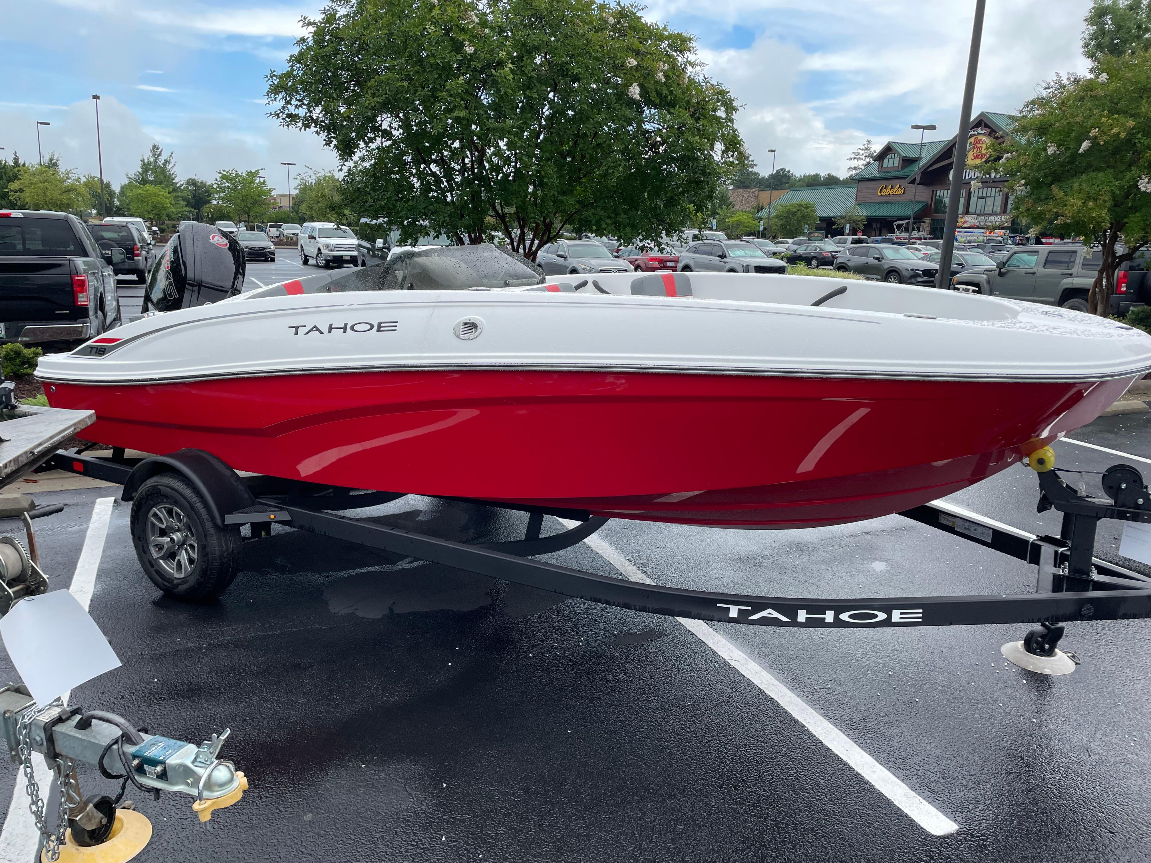 Tahoe T18 2025 Tahoe T18 boat in parking lot, red and white design, on trailer.