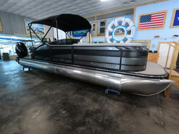Vanderbilt 700T 2023 Vanderbilt 700T pontoon boat in showroom with American flag and life ring.