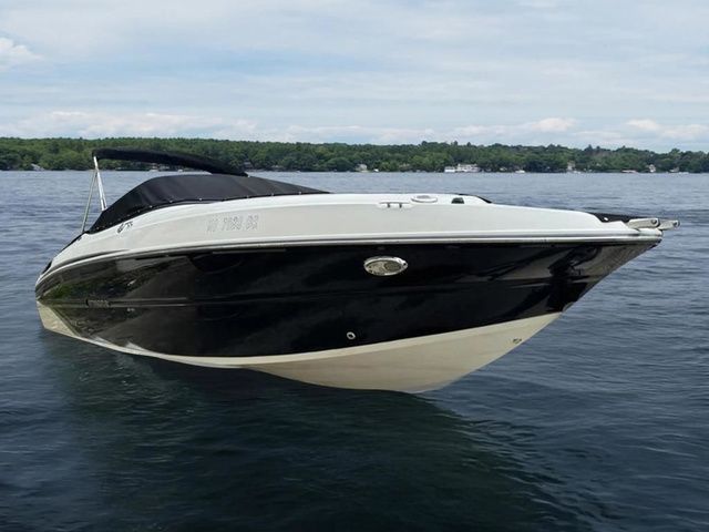 Stingray 235LR 2015 Stingray 235LR boat on calm lake waters, black and white design.