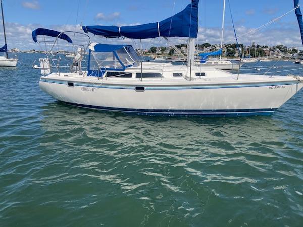 Catalina 30 MkIII 1995 Catalina 30 Mk III sailboat on calm water with blue sails.