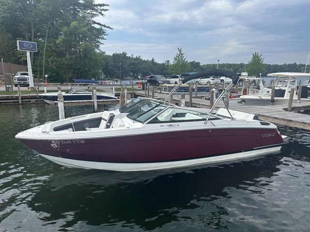 Cobalt R6 2024 Cobalt R6 boat docked at a marina, featuring sleek design and maroon exterior.
