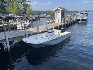 Boston Whaler 170 Montauk 2024 Boston Whaler 170 Montauk docked at a scenic lakeside marina.