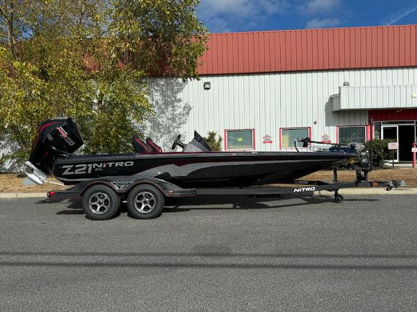 Nitro Z21 XL 2025 Nitro Z21 XL boat on trailer, parked outside industrial building.