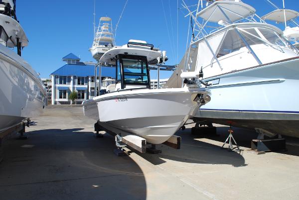Everglades 253 2021 Everglades 253 boat docked at a marina, surrounded by other boats.