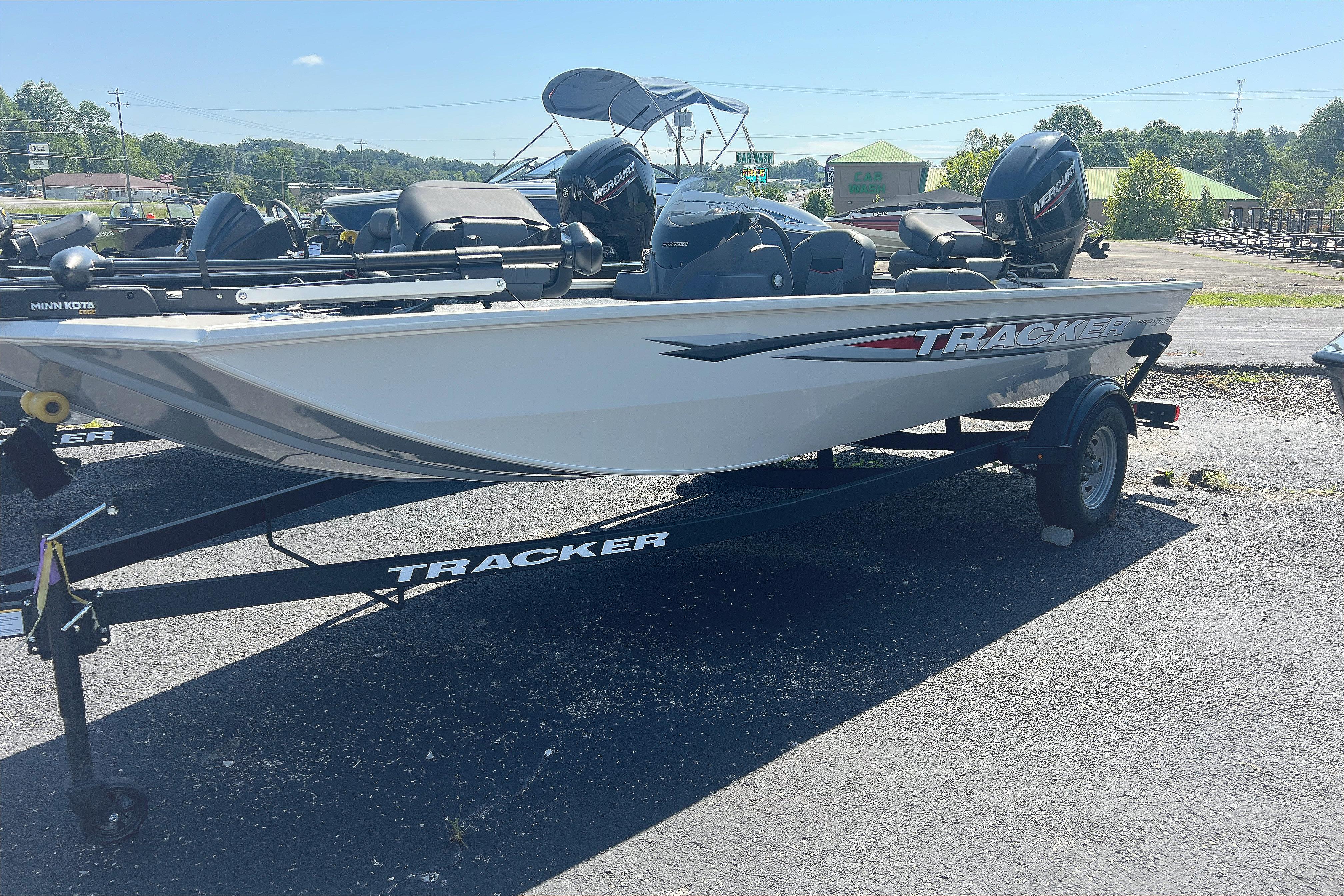 Tracker Pro 170 2026 Tracker Pro 170 boat on trailer, parked outdoors under clear sky.