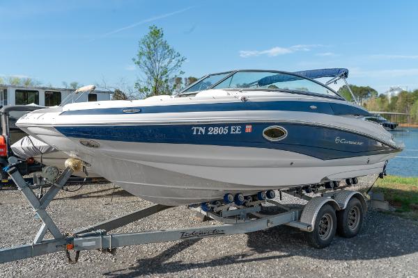 Crownline Eclipse E2 2012 Crownline Eclipse E2 boat on trailer by a lake, clear sky background.