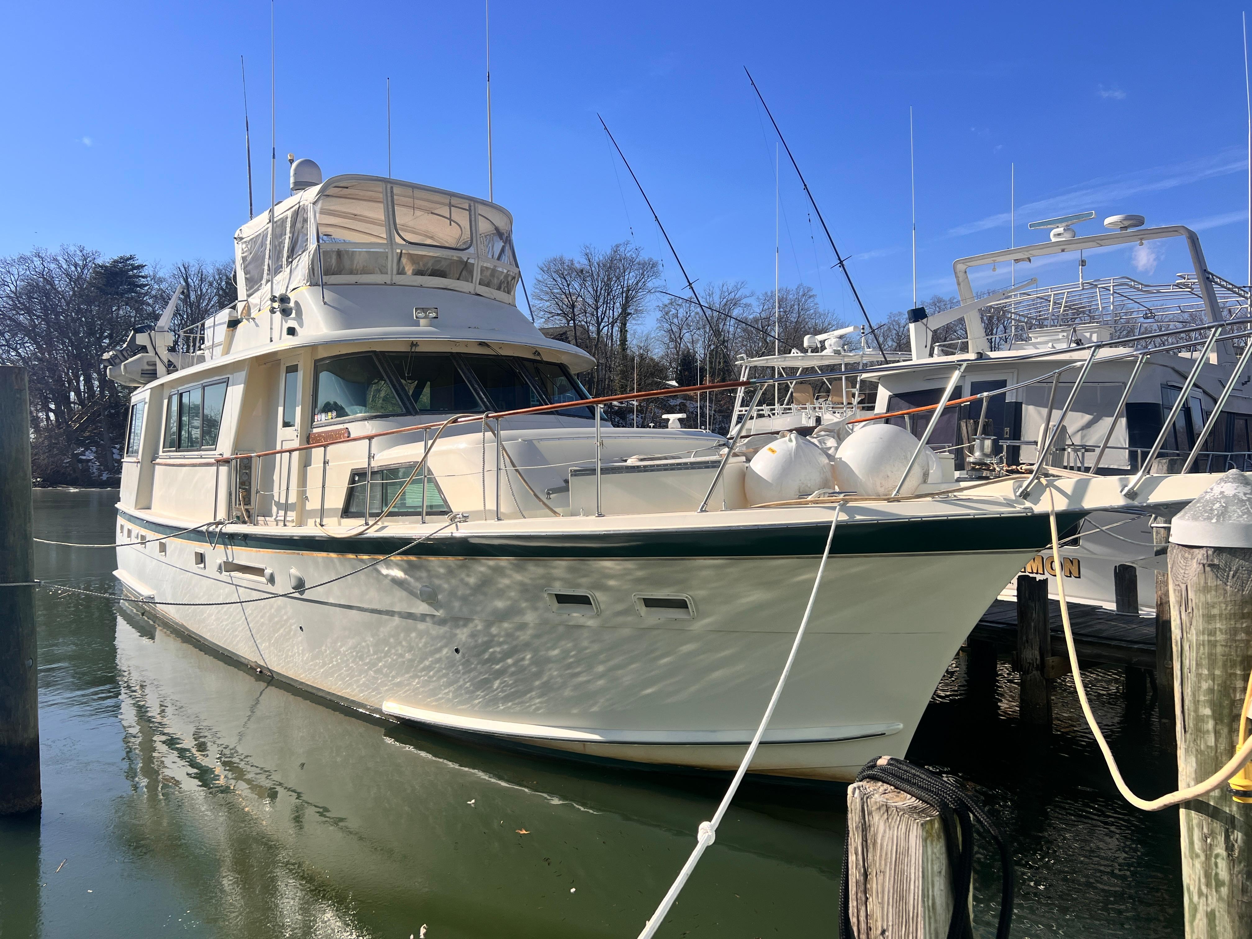 Hatteras 58 MY 1980 Hatteras 58 MY yacht docked in a marina under clear blue skies.