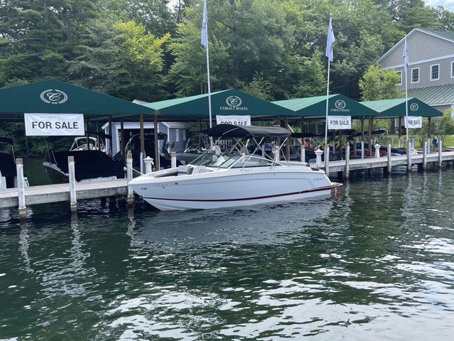 Cobalt R6 2024 Cobalt R6 boat for sale at dock with green canopies.